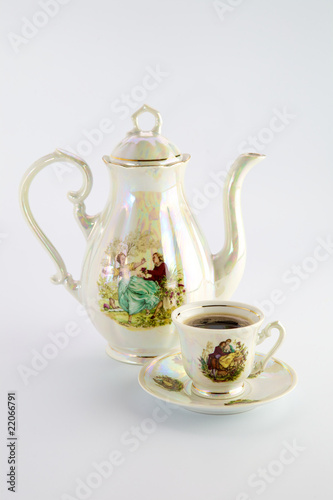 Beautiful old coffee pot and cup with a drawing