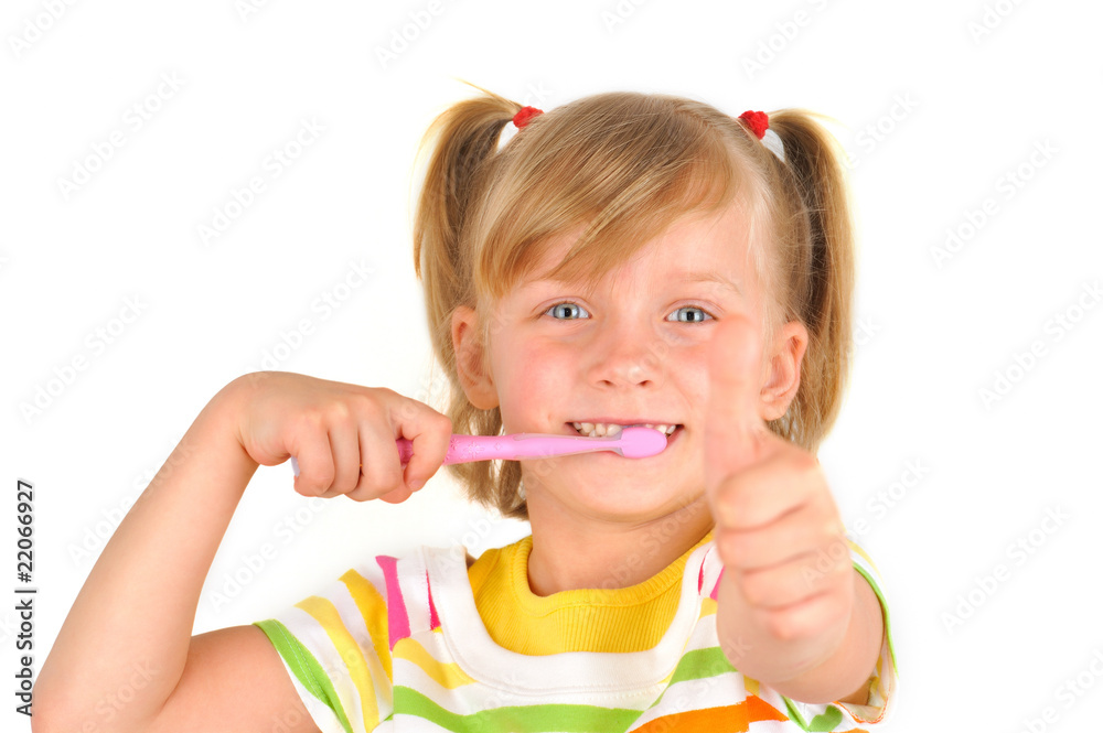 Fototapeta premium Cute little girl is brushing teeth