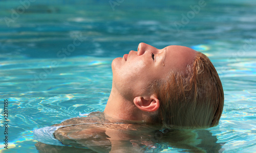 Portrait of woman relaxing in swimming pool