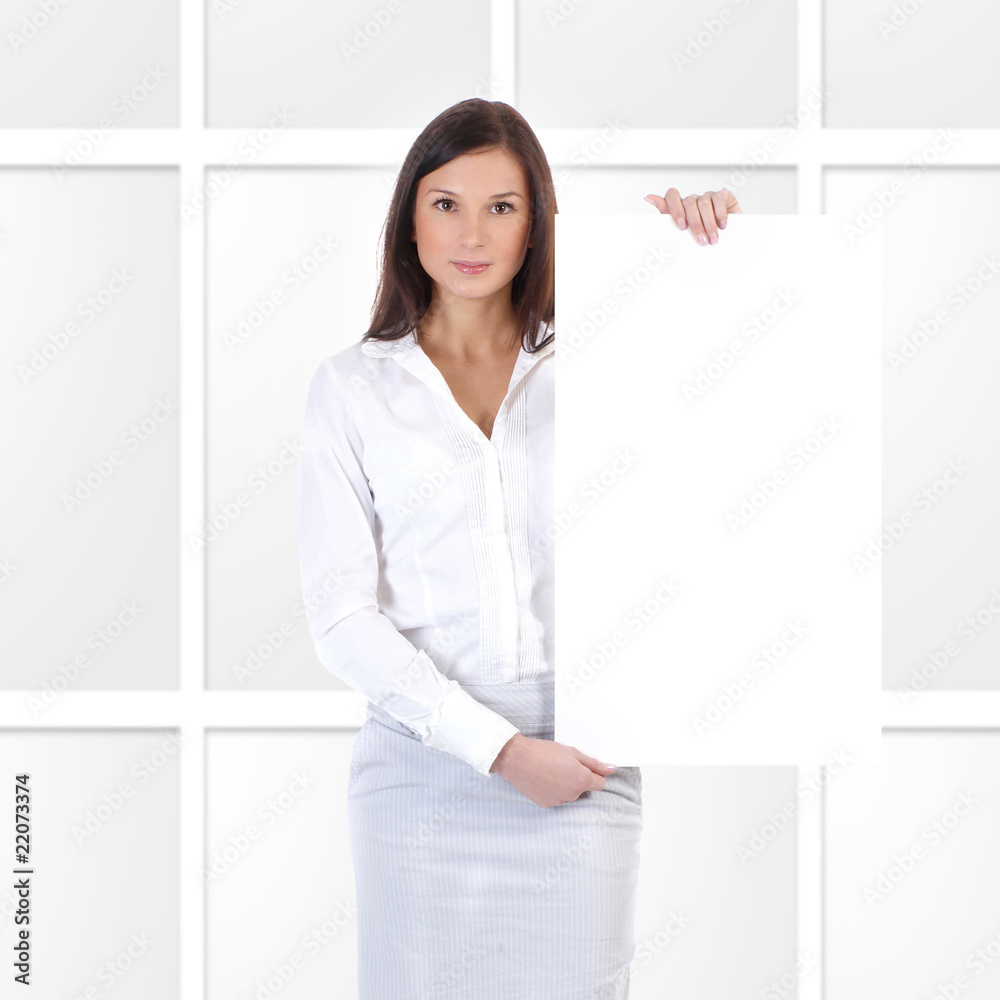 A young and attractive business woman is holding a blank poster A young and attractive business woman is holding a blank poster