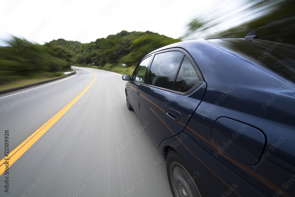 The car moves at great speed at the mountain road