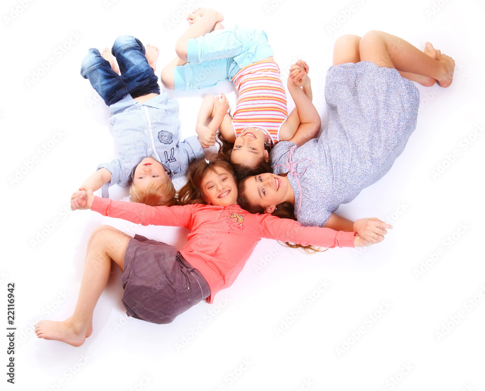 Children lying on the floor holding hands