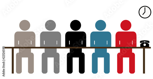 Associates listening behind table in board room