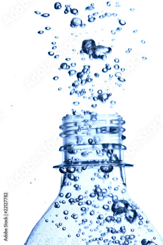 bottle in pure water with waves and bubbles