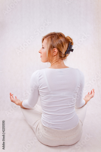 young woman relaxing (back) - on white background