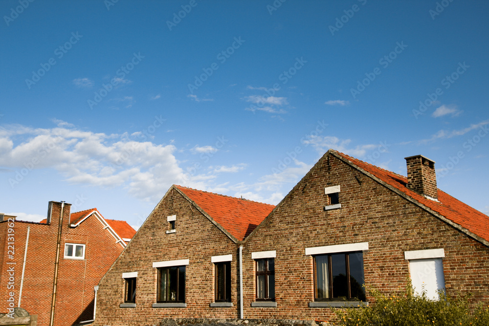 Brick houses on clear blue sky