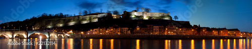 Night panorama of a river, city, mountain and fort