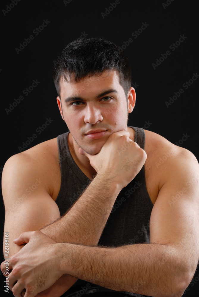a handsome young man posing on a black background a handsome young man posing on a black background