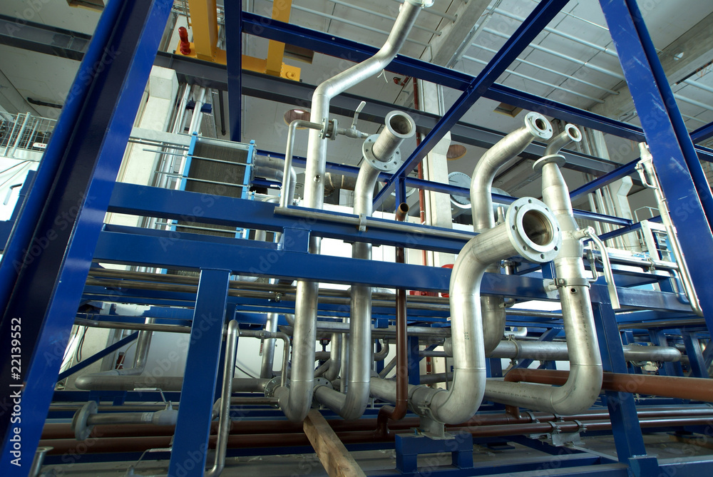 Pipes, tubes, machinery and steam turbine at a power plant Pipes, tubes, machinery and steam turbine at a power plant