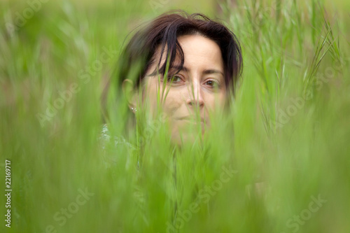 woman face portrait hidden in grass