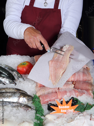 Fischverkäuferin mit Rotbarsch photo