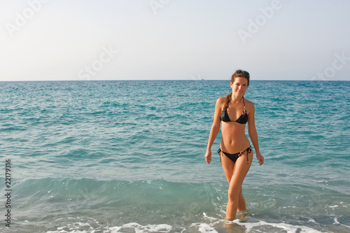 Beautiful young woman posing on the beach