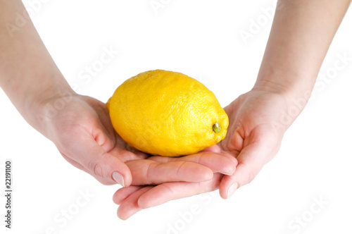 Big lemon in hands isolated on white