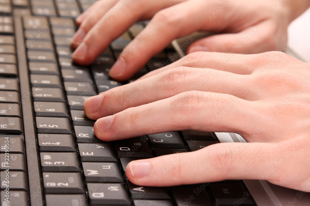 Closeup of male fingers typing a document on the black laptop Closeup of male fingers typing a document on the black laptop