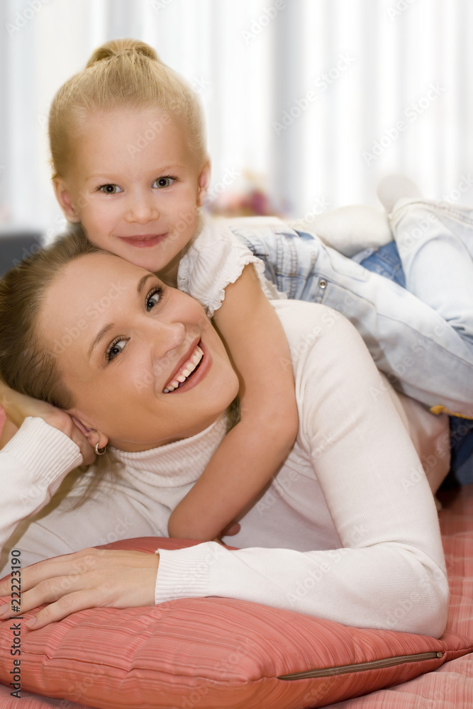 Mother and daughter posing happily. Focus on mother. Mother and daughter posing happily. Focus on mother.