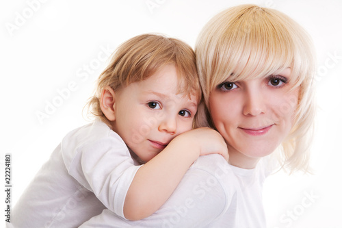 Portrait of little boy embracing woman. Isolated on the white.