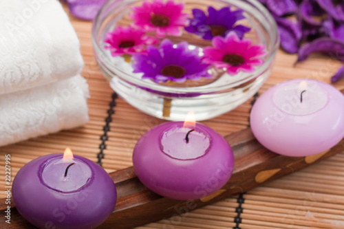 purple candles and flowers in spa setting  2 