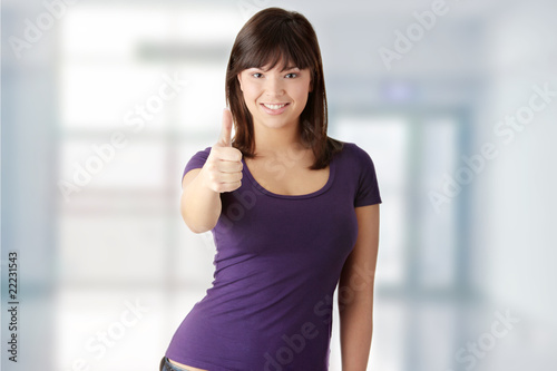 Young woman with thumbs up © Piotr Marcinski