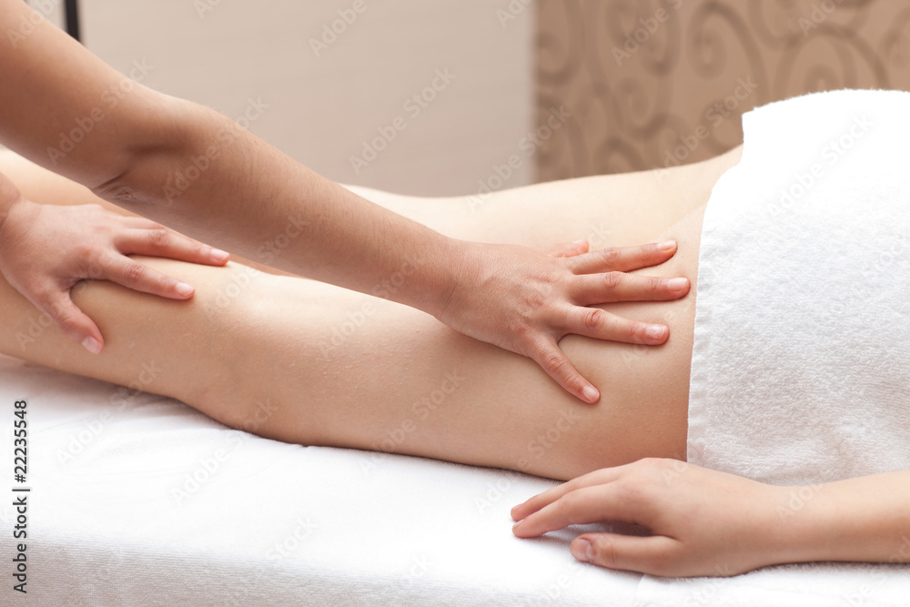 Woman enjoying a leg massage in a spa setting