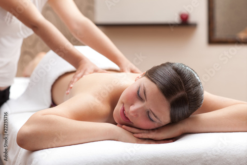 Woman enjoying a back massage in a spa setting