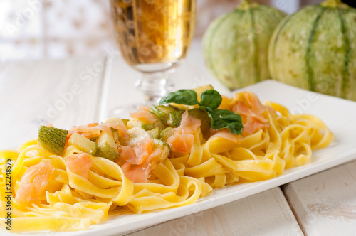 pasta with smoked salmon, zucchinis and glass of white wine