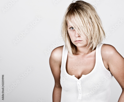 Pensive Blonde Female in White Vest