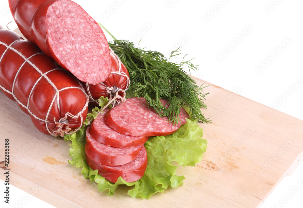 long loaf of smoked sausage lies on chopping board long loaf of smoked sausage lies on chopping board