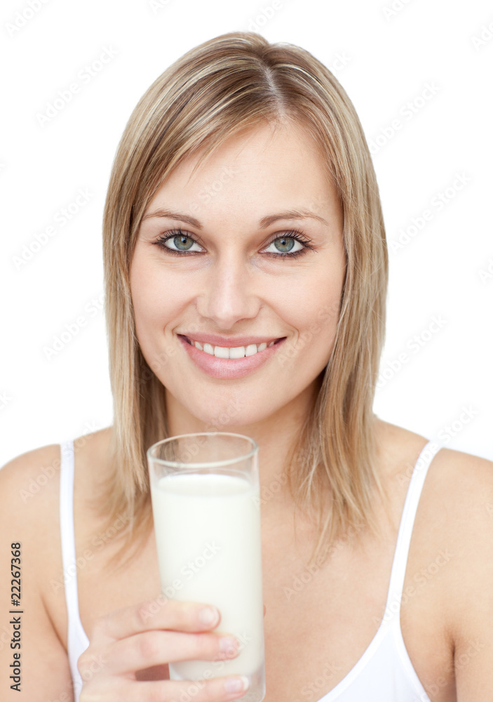 Smiling woman holding a glass of milk Smiling woman holding a glass of milk