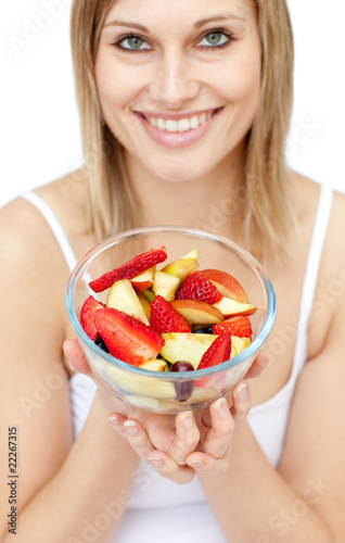 Happy woman holding a fruit salad