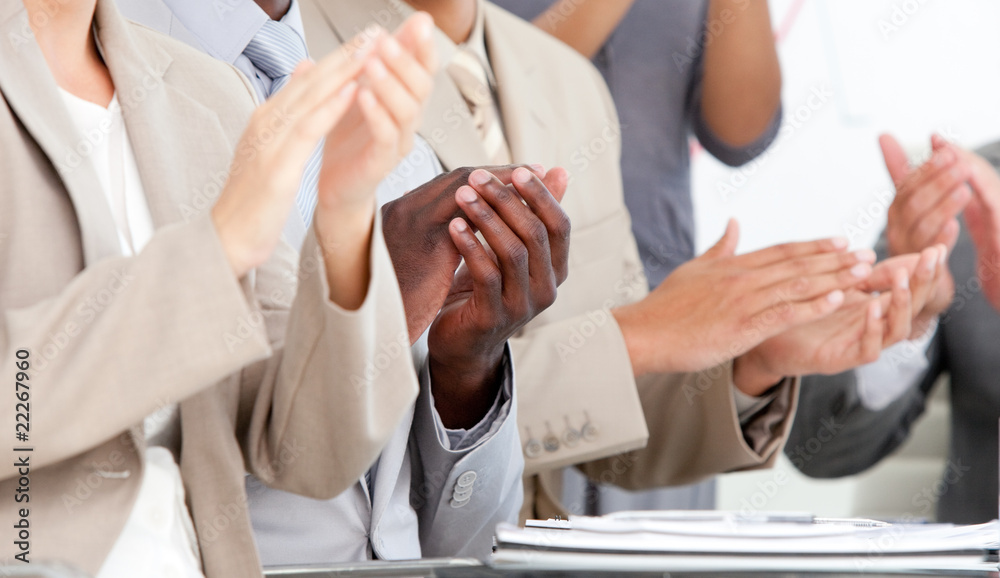 Close-up of business people applauding in a meeting