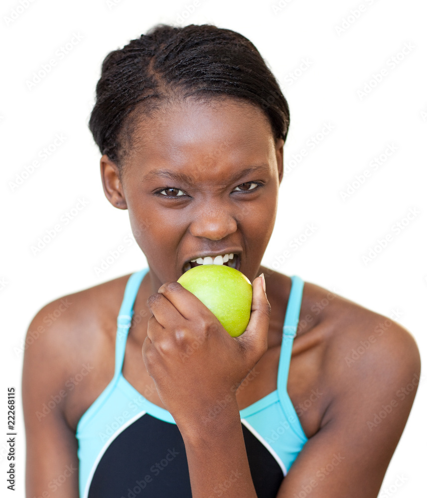 Obraz premium Cheerful fitness woman eating an apple