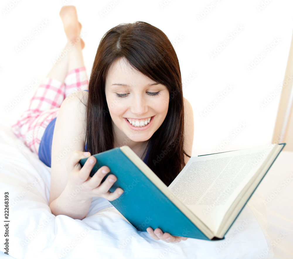 Portrait of a confident teen girl studying lying on a bed Portrait of a confident teen girl studying lying on a bed