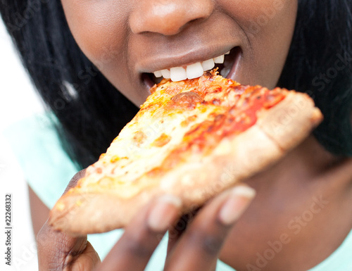 Close-up of a teen girl eating a pizza