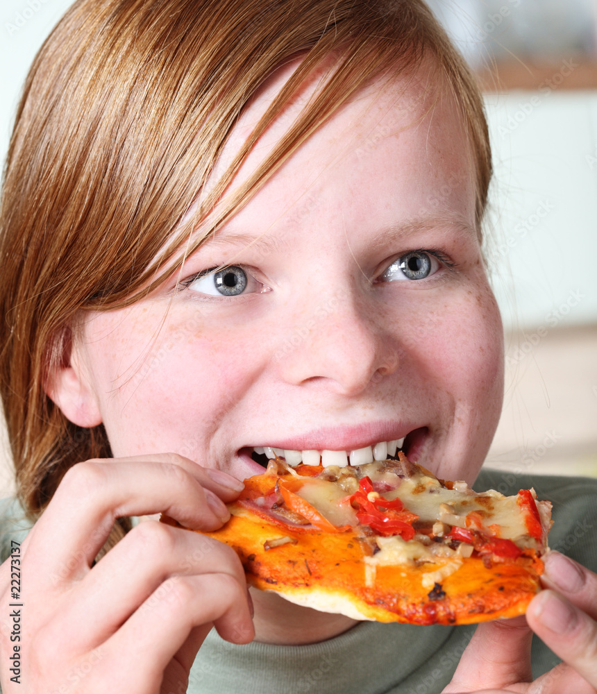 Teenage girl eating pizza
