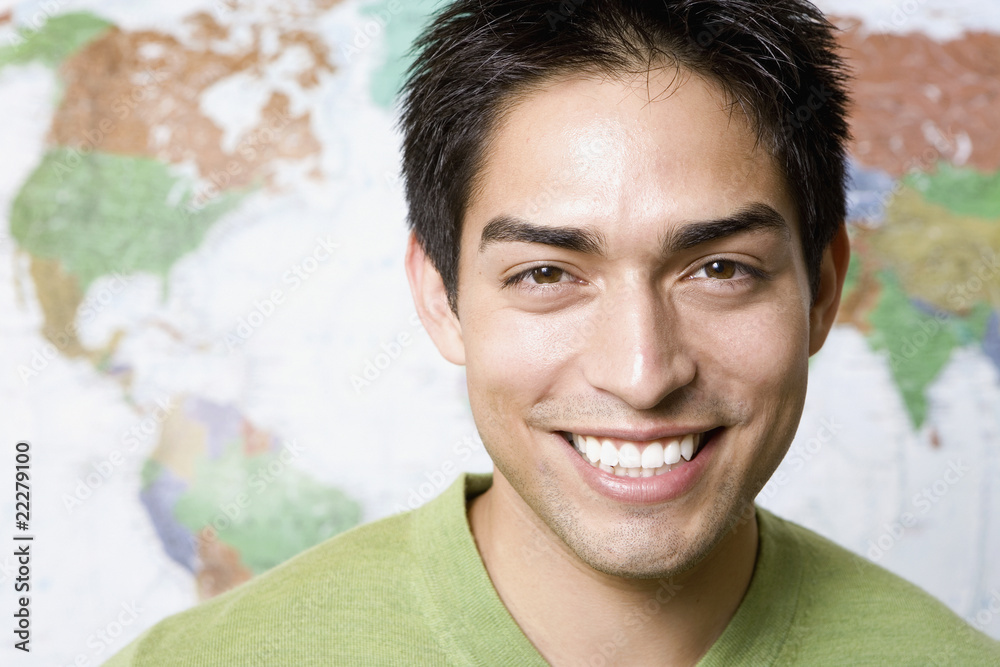 Portrait of Pacific Islander man in front of world map Portrait of Pacific Islander man in front of world map