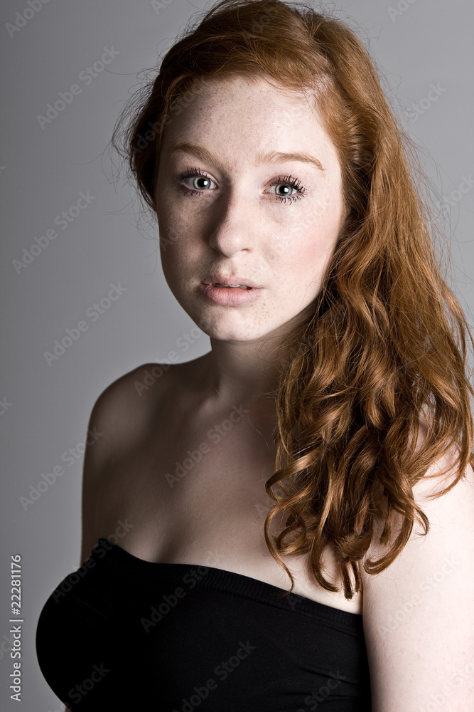 Foto Stock Pretty Red Headed Teenage Girl with Freckles | Adobe Stock