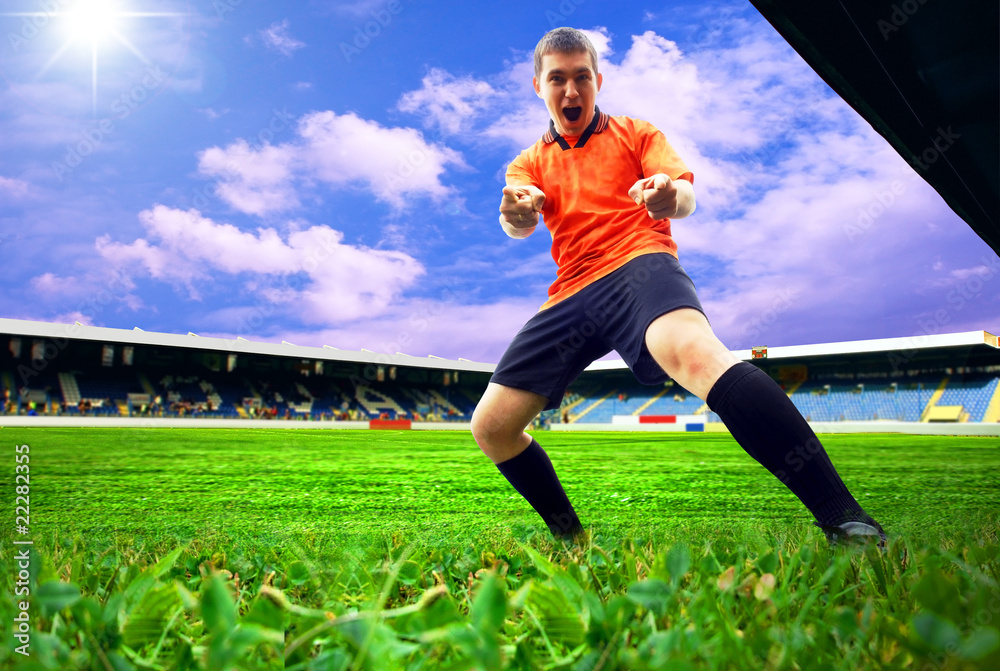 Happiness football player after goal on the field of stadium wit Happiness football player after goal on the field of stadium wit