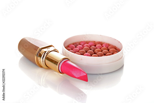 New lipstick and pink rouge on white background