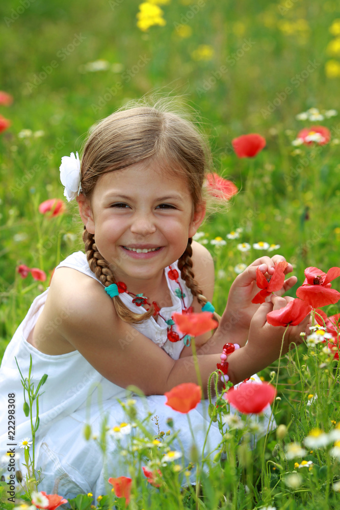 Pretty young girl holding a red poppy Pretty young girl holding a red poppy