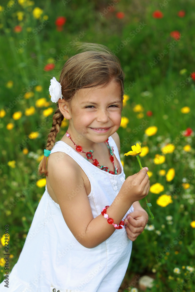Pretty young girl holding a daisy flower Pretty young girl holding a daisy flower