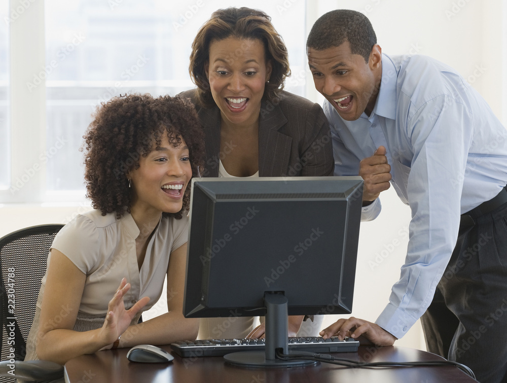 African people looking excited working on computer African people looking excited working on computer