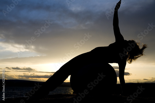 Fototapeta Naklejka Na Ścianę i Meble -  silhouette of woman laying on ball