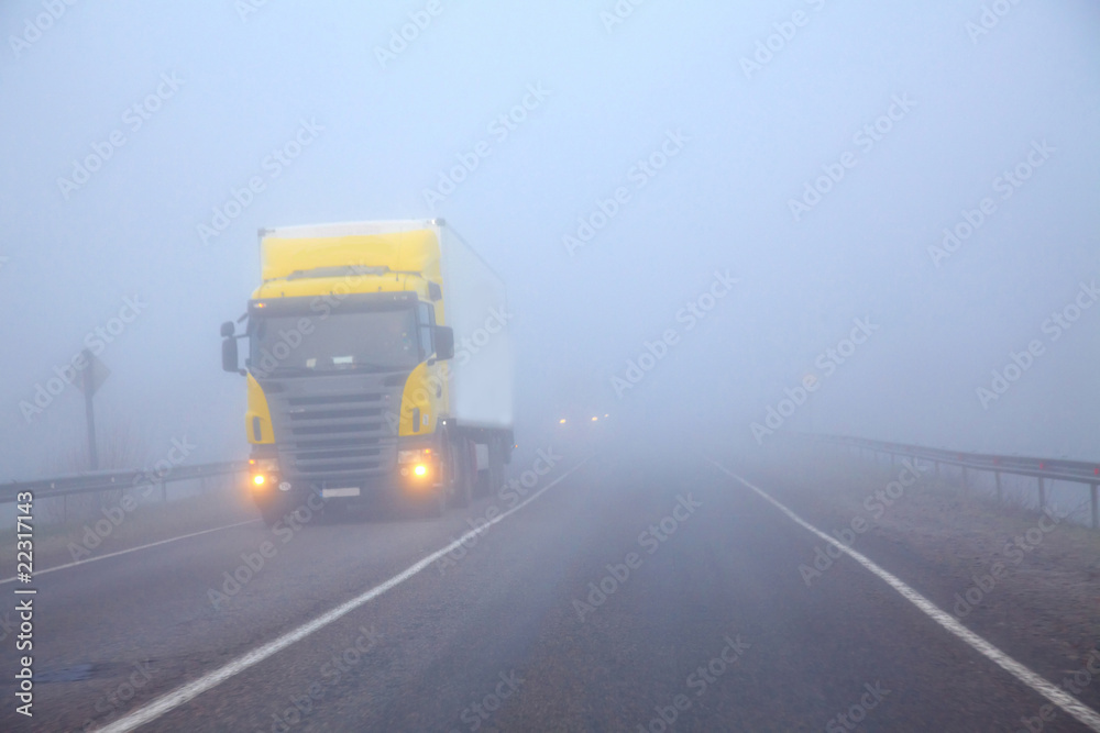The truck on a line in a fog
