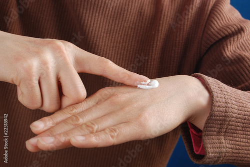 woman applying skin lotion
