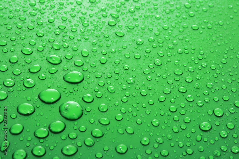 Green water drops background with big and small drops