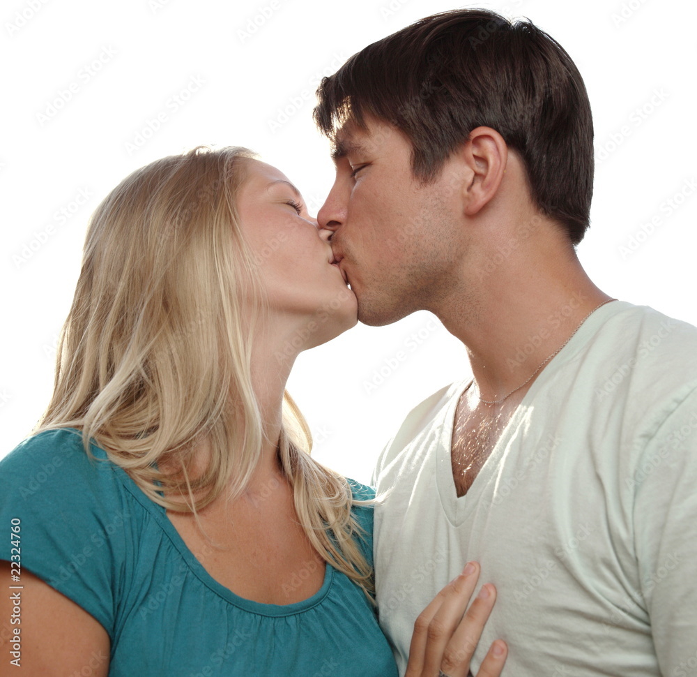 Young lovely couple kissing lovingly - isolated on white Young lovely couple kissing lovingly - isolated on white