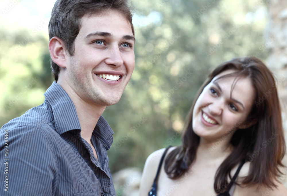Beautiful young couple outdoors - smiling having fun. Beautiful young couple outdoors - smiling having fun.