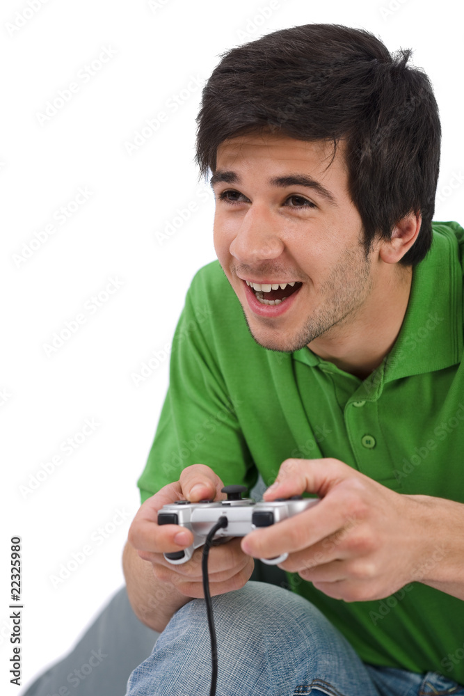 Young happy man playing video game with control pad Young happy man playing video game with control pad