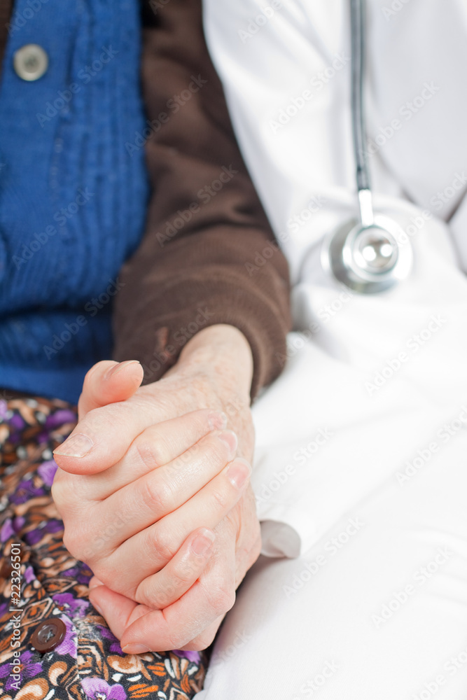 Young sweet doctor holds the old woman's hand Young sweet doctor holds the old woman's hand