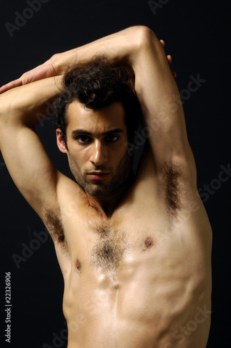 young sensual man on a black background